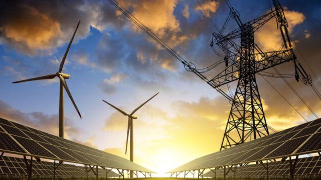 Solar panels, pylon, and wind turbines in a field